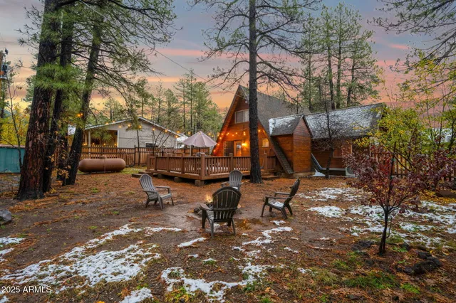 a view of a house with a yard wooden fence and a tree