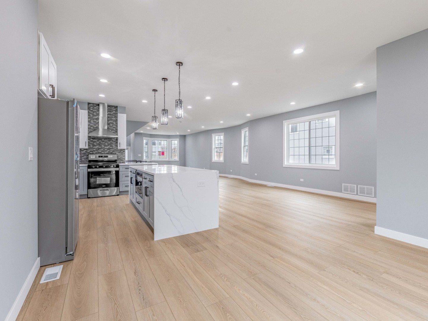 3548 Clinton Avenue Berwyn, IL 60402 - Photo 13 of 49 a view of kitchen with kitchen island wooden floor center island and stainless steel appliances