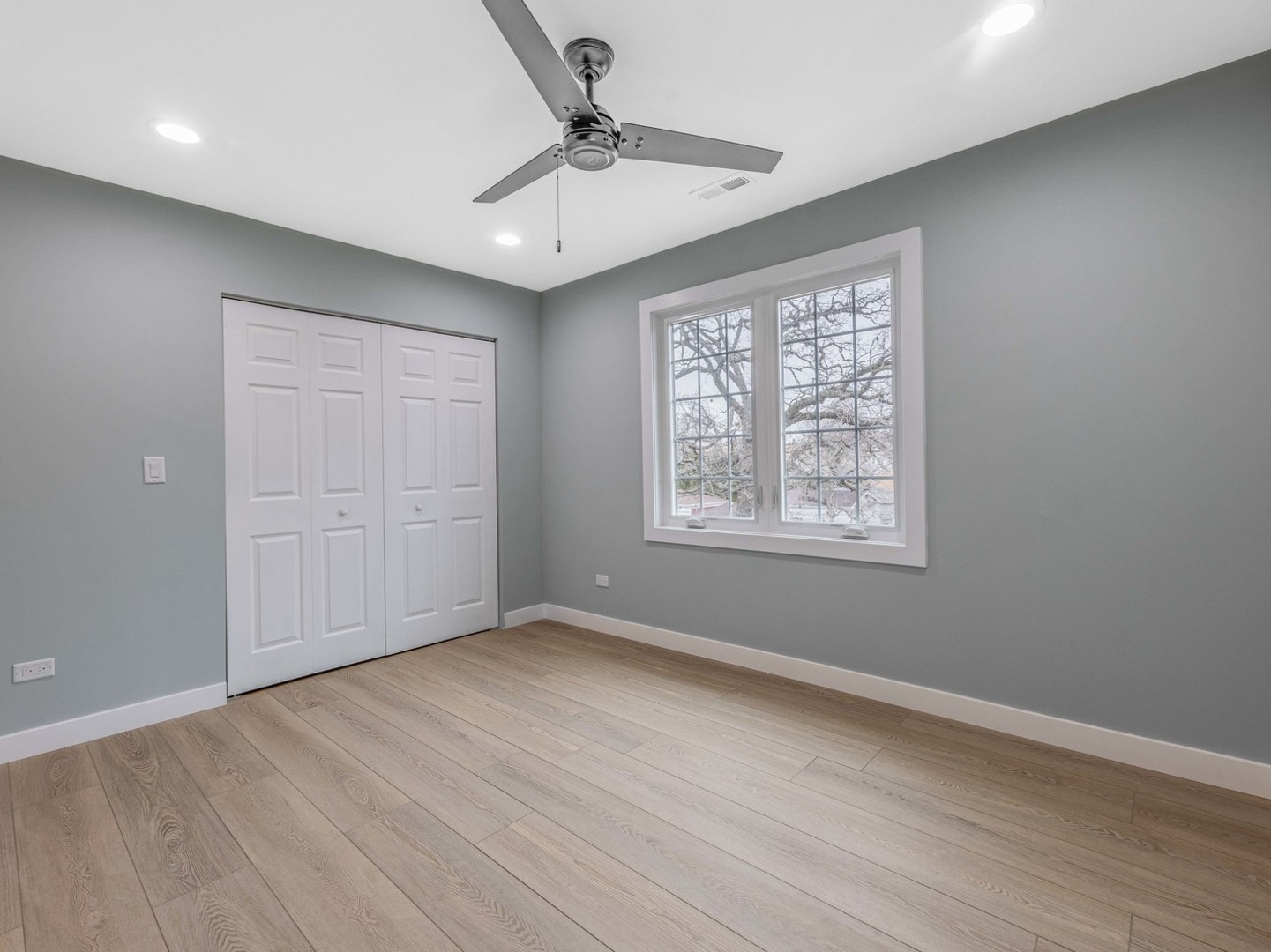 3548 Clinton Avenue Berwyn, IL 60402 - Photo 21 of 49 an empty room with wooden floor chandelier fan and windows