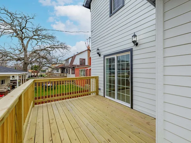 a view of balcony with wooden floor and fence