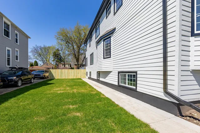 a view of a white house with a yard