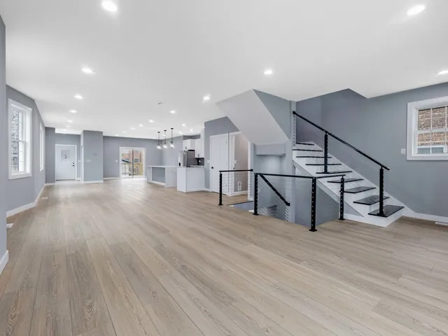 a view of entryway with wooden floor and stairs