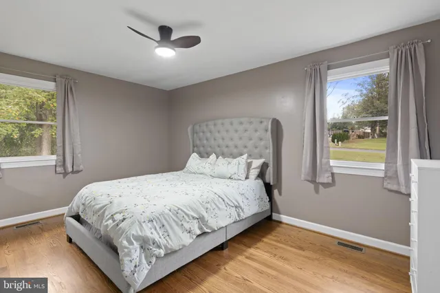 a bedroom with a bed and a flat tv screen on dresser