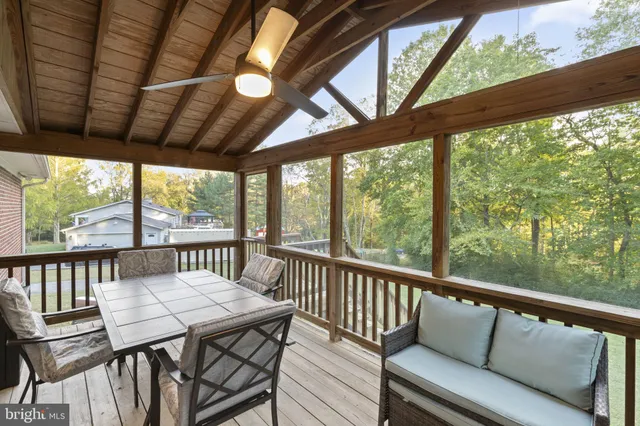 a view of a house with backyard and trees