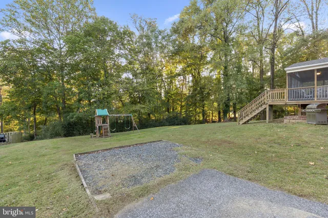a front view of a house with a garden and deck