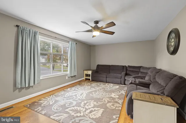 a living room with a flat screen tv and a large window