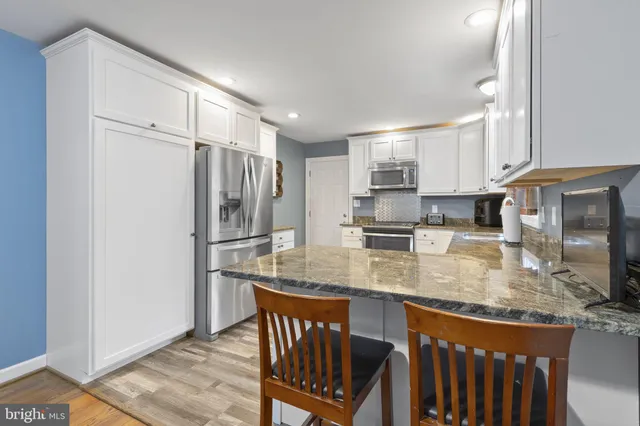 a kitchen with a sink window and cabinets