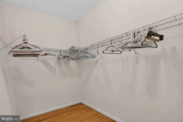 a bathroom with a granite countertop double vanity sink and a mirror