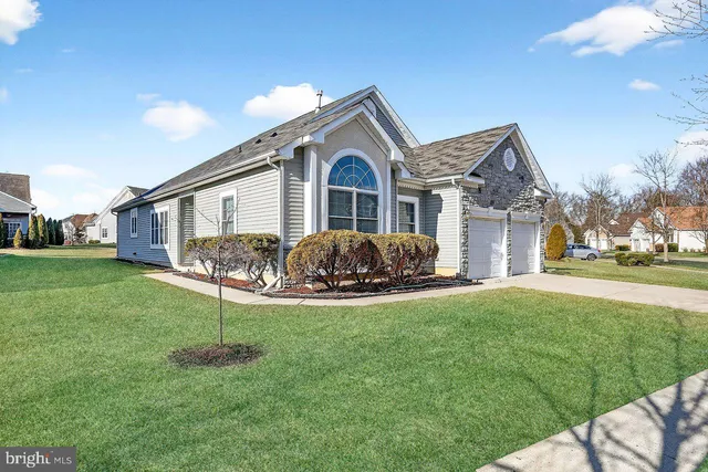 a front view of a house with garden and porch