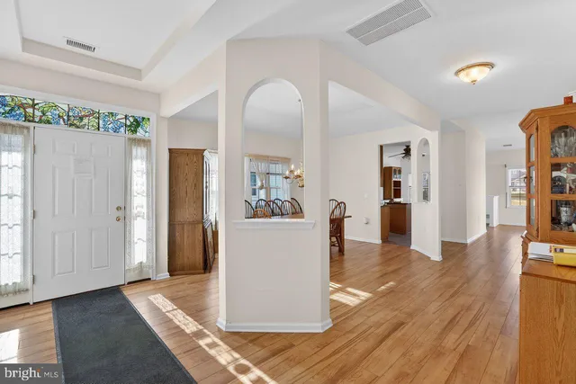 a view of a living room and kitchen with a wooden floor