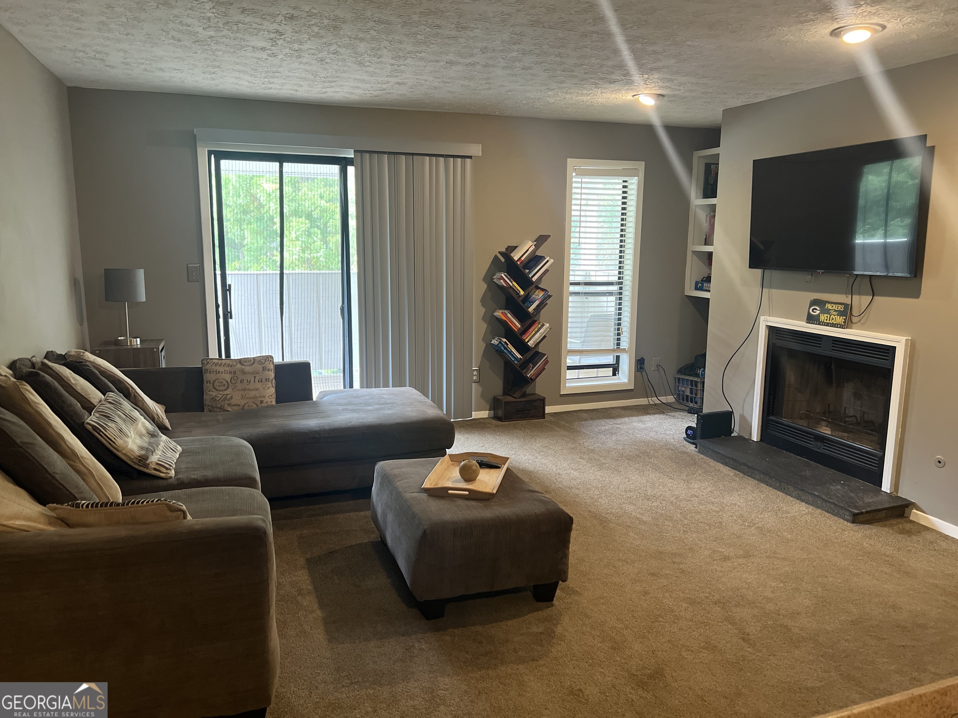 709 Wynnes Ridge Circle Marietta, GA 30067 - Photo 1 of 11 a living room with furniture a flat screen tv and a fireplace