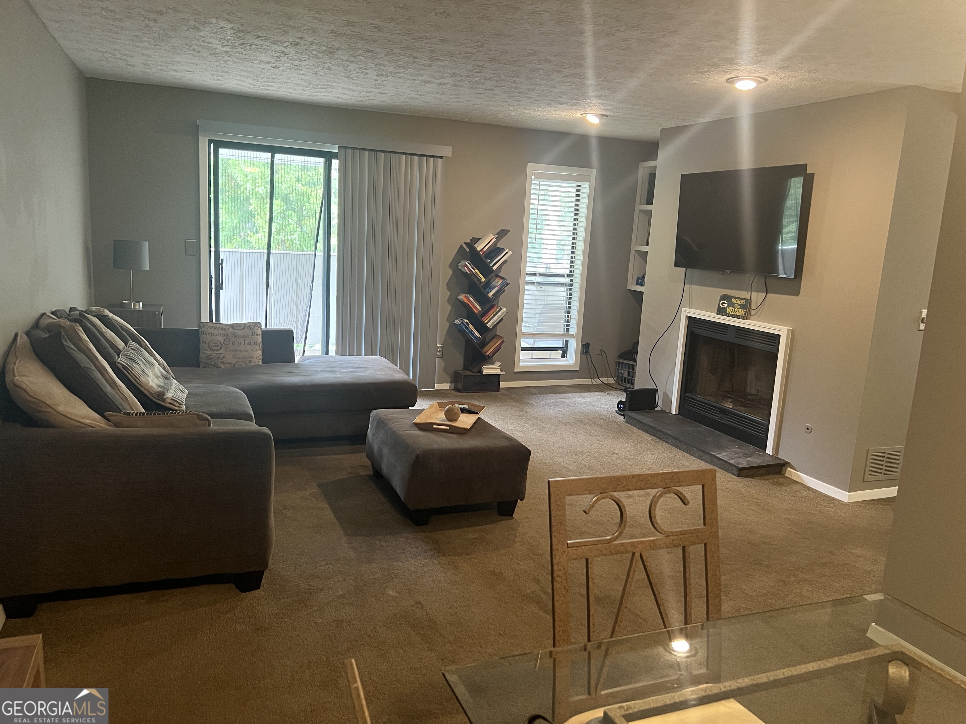 709 Wynnes Ridge Circle Marietta, GA 30067 - Photo 11 of 11 a living room with furniture a flat screen tv and a fireplace