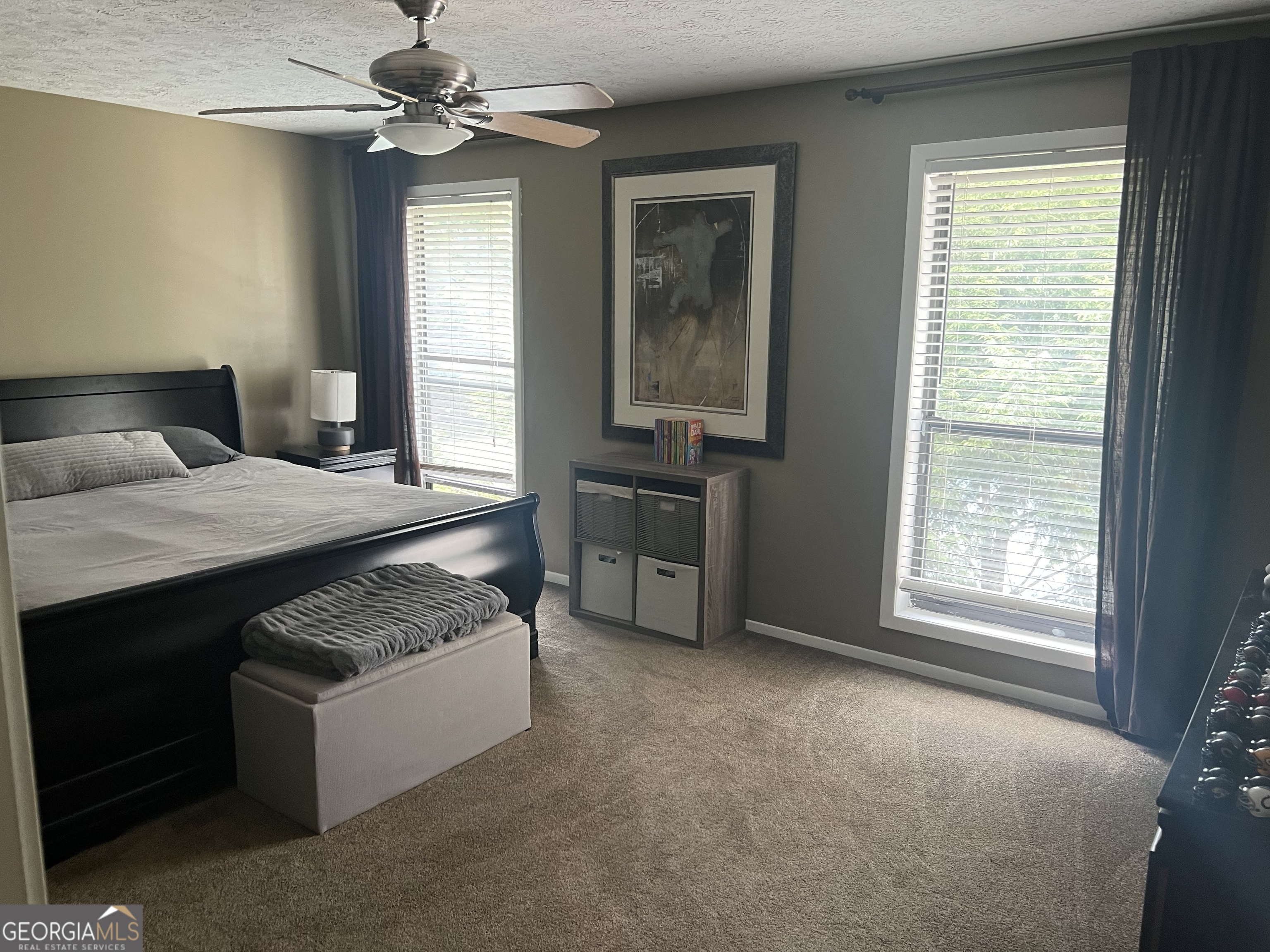 709 Wynnes Ridge Circle Marietta, GA 30067 - Photo 5 of 11 a bedroom with a bed and a chandelier