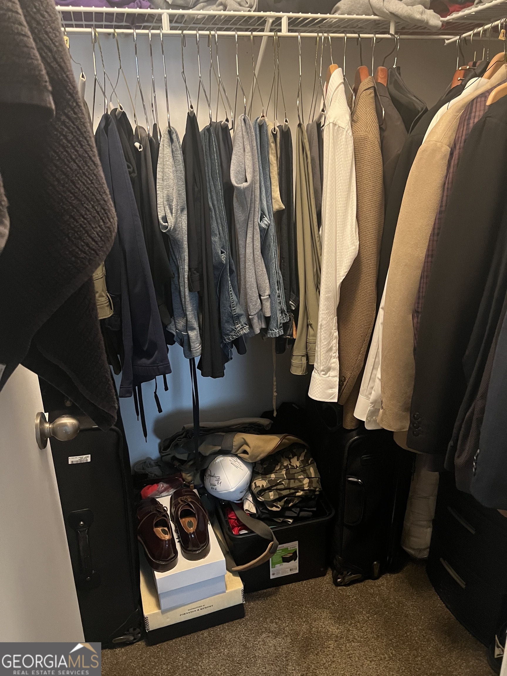 709 Wynnes Ridge Circle Marietta, GA 30067 - Photo 6 of 11 a view of walk in closet with clothes and shoes