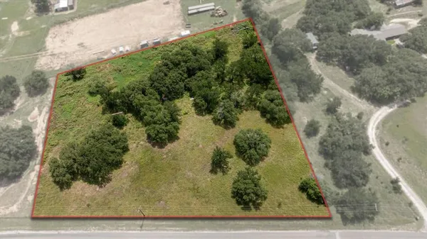 an aerial view of a residential houses with outdoor space