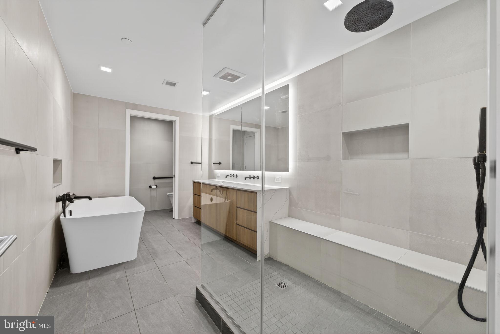 1332 8th Street Northwest Washington, DC 20001 - Photo 23 of 46 a bathroom with a bathtub a sink a toilet and a shower