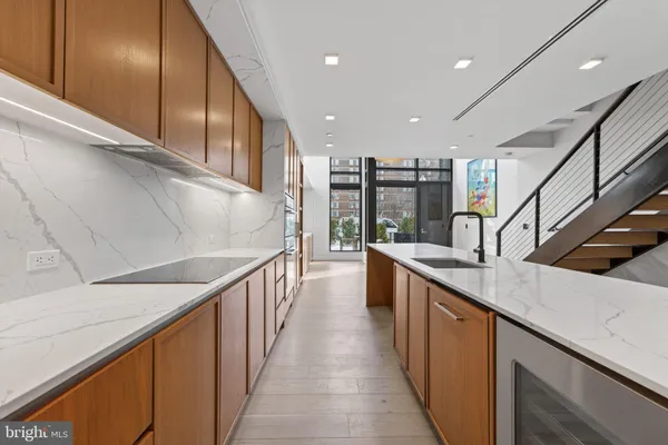 a kitchen with counter top space and lots of frames on wall