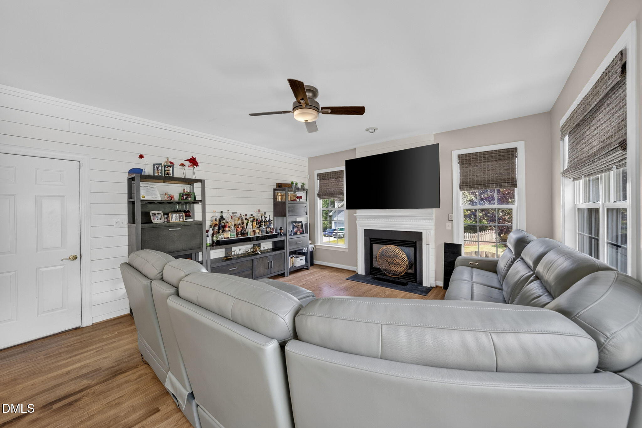 1258 Horsham Way Apex, NC 27502 - Photo 16 of 32 a living room with furniture a fireplace and a flat screen tv