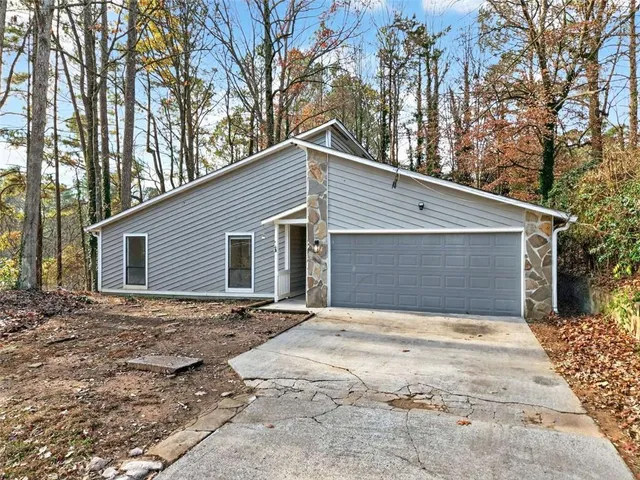 a view of a house with a yard and garage