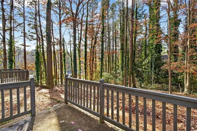 a view of a yard in front of a house with large trees