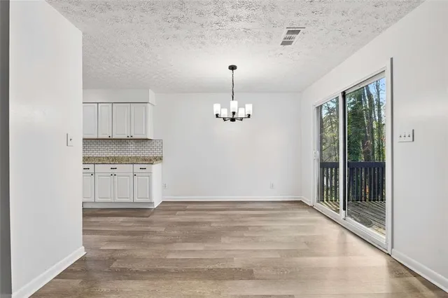 a view of a kitchen with a sink stainless steel appliances and cabinets