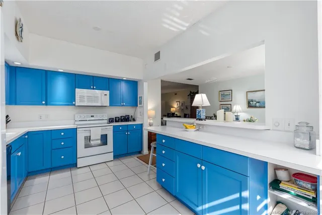 a kitchen with a sink a stove and cabinets