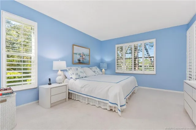 a spacious bedroom with a bed and a window