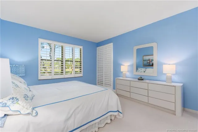 a spacious bedroom with a bed and a window