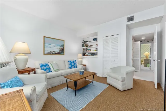 a living room with furniture and a lamp