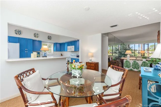 a dining room with furniture and a kitchen view