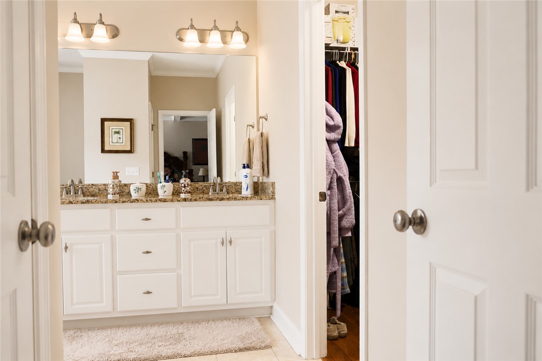 190 Fred Bradford Road Iva, SC 29655 - Photo 17 of 32 This bathroom features a double vanity with granite counters and convenient closet access.