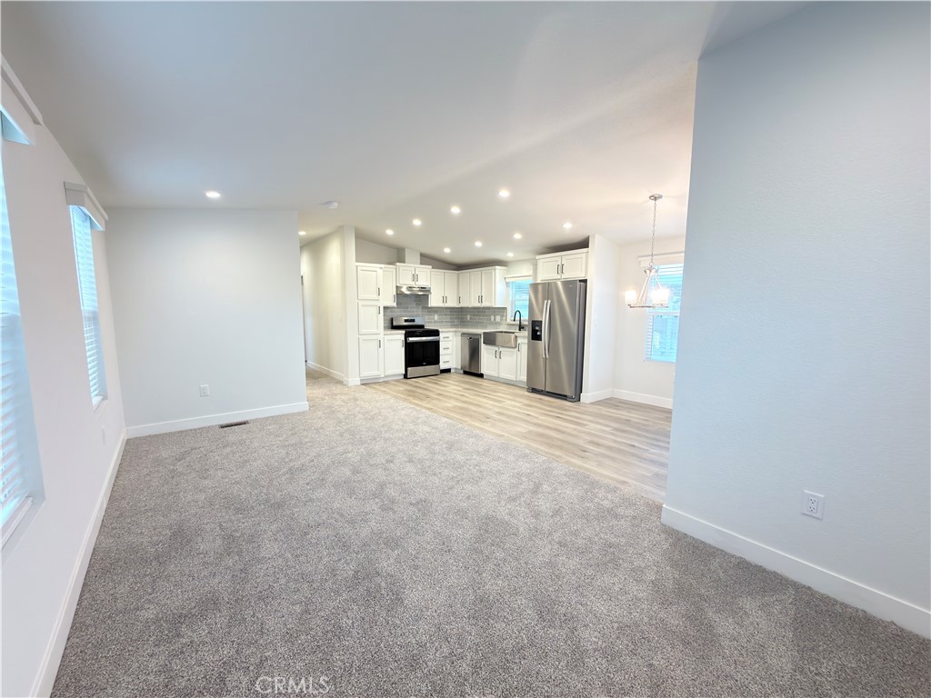 13061 Fairview Street, Unit 22 Garden Grove, CA 92843 - Photo 11 of 25 a view of a kitchen with a sink and a stove