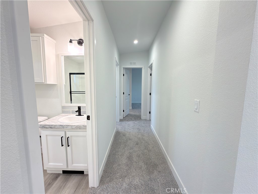 13061 Fairview Street, Unit 22 Garden Grove, CA 92843 - Photo 12 of 25 a bathroom with white cabinets sink and mirror