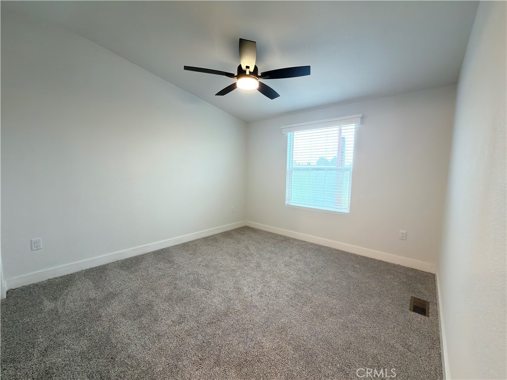 13061 Fairview Street, Unit 22 Garden Grove, CA 92843 - Photo 13 of 25 an empty room with a window and a fan