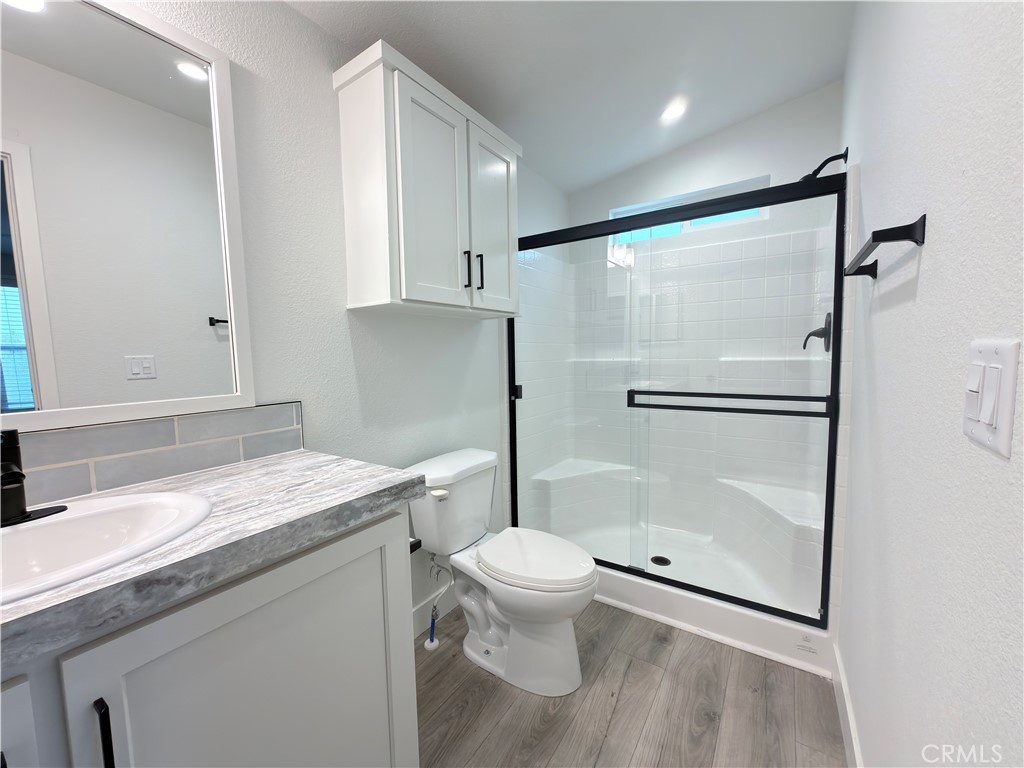 13061 Fairview Street, Unit 22 Garden Grove, CA 92843 - Photo 18 of 25 a bathroom with a granite countertop sink toilet and shower