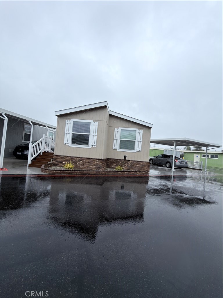 13061 Fairview Street, Unit 22 Garden Grove, CA 92843 - Photo 2 of 25 a living room with furniture a flat screen tv and kitchen view