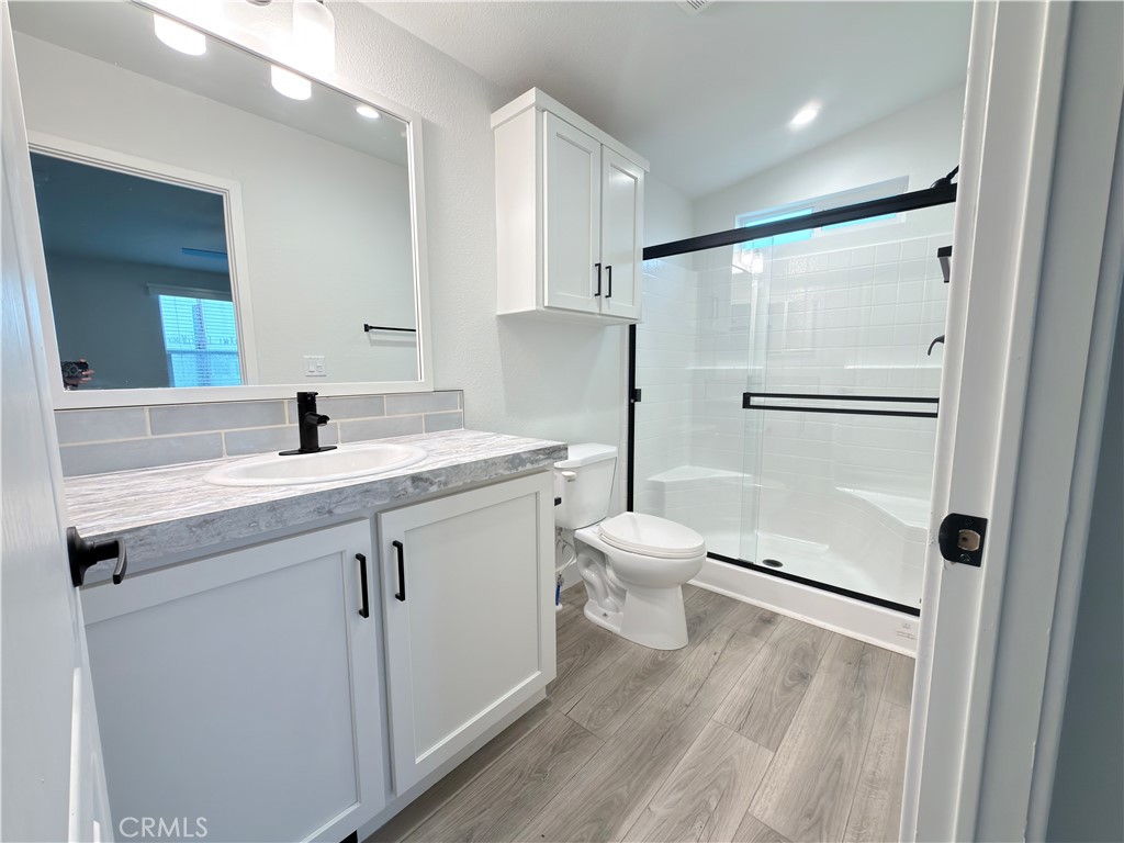 13061 Fairview Street, Unit 22 Garden Grove, CA 92843 - Photo 23 of 25 a bathroom with a sink toilet and shower