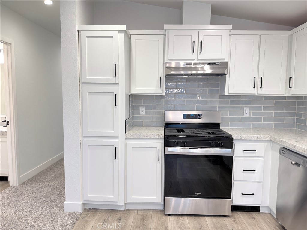 13061 Fairview Street, Unit 22 Garden Grove, CA 92843 - Photo 5 of 25 a kitchen with white cabinets and appliances