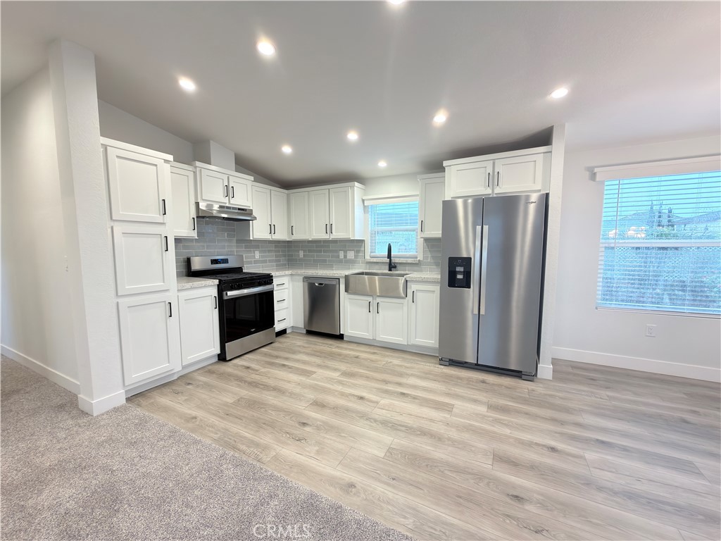 13061 Fairview Street, Unit 22 Garden Grove, CA 92843 - Photo 7 of 25 a kitchen with stainless steel appliances granite countertop a refrigerator sink and cabinets