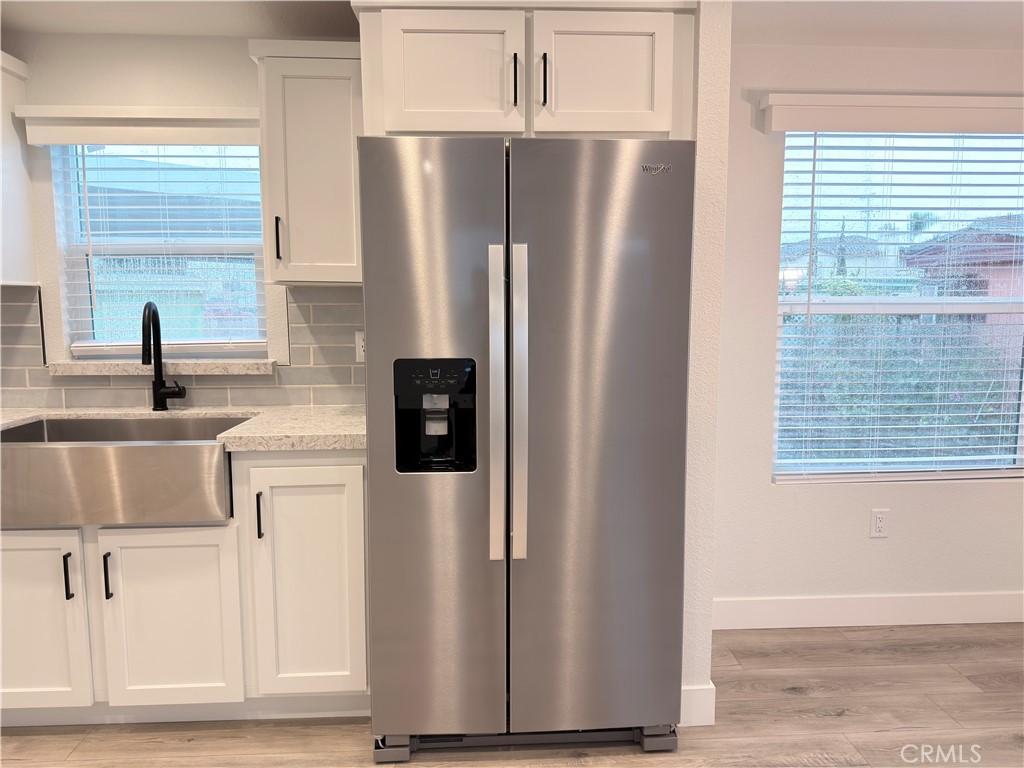 13061 Fairview Street, Unit 22 Garden Grove, CA 92843 - Photo 8 of 25 a kitchen with stainless steel appliances granite countertop a refrigerator and a sink
