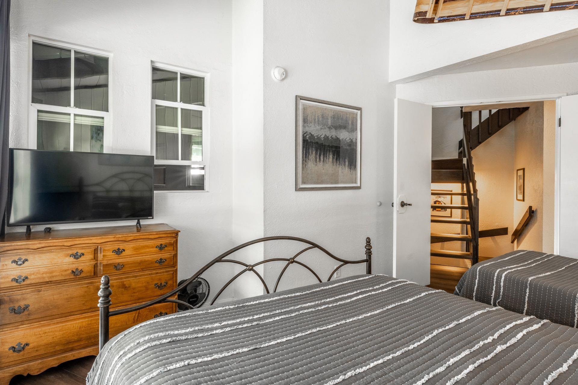 286 Old Mammoth Road, Unit 71 Mammoth Lakes, CA 93546 - Photo 11 of 24 a bedroom with a bed and a flat screen tv
