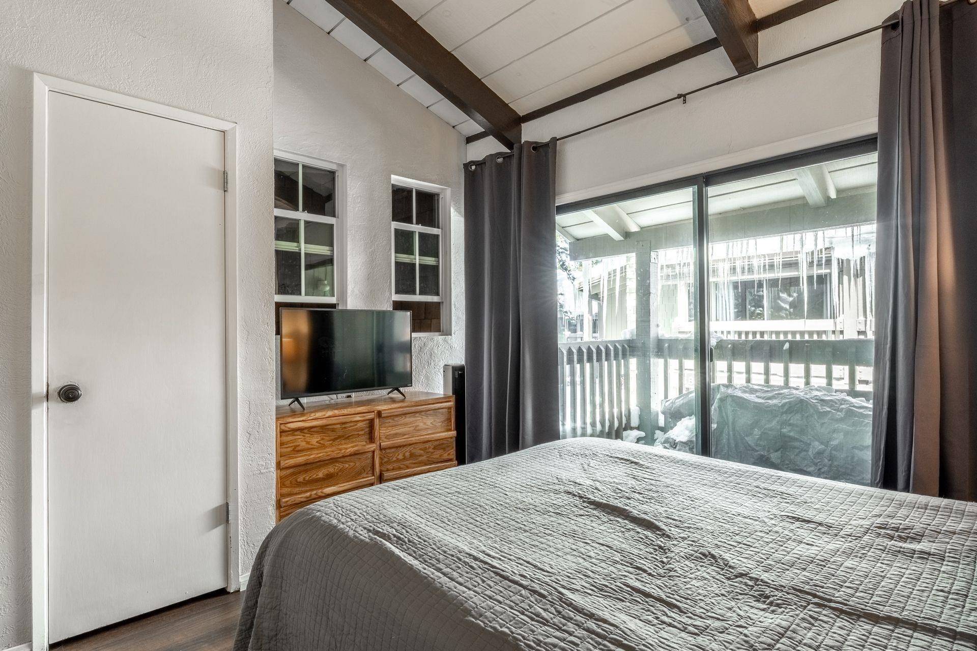 286 Old Mammoth Road, Unit 71 Mammoth Lakes, CA 93546 - Photo 14 of 24 a bedroom with a bed and a flat screen tv