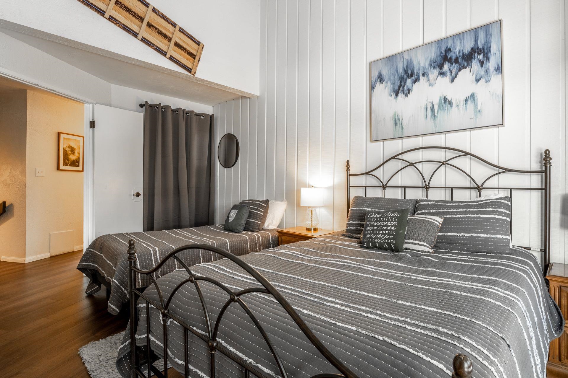 286 Old Mammoth Road, Unit 71 Mammoth Lakes, CA 93546 - Photo 10 of 24 a bedroom with a bed and a painting on the wall