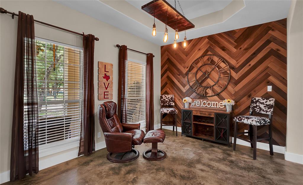 37 Bluebonnet Loop Morgan's Point Resort, TX 76513 - Photo 8 of 38 Accent wall with chevron wood paneling, tray ceiling, and exposed bulb pendant lighting