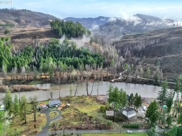 a view of a lake in middle of the forest