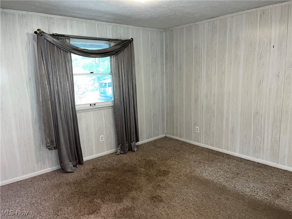 2300 River Road Willoughby, OH 44094 - Photo 9 of 28 Carpeted empty room featuring a textured ceiling and baseboards