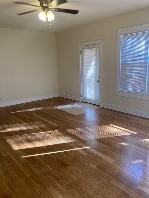 2710 Whitis Avenue, Unit A Austin, TX 78705 - Photo 4 of 20 an empty room with wooden floor fan and windows