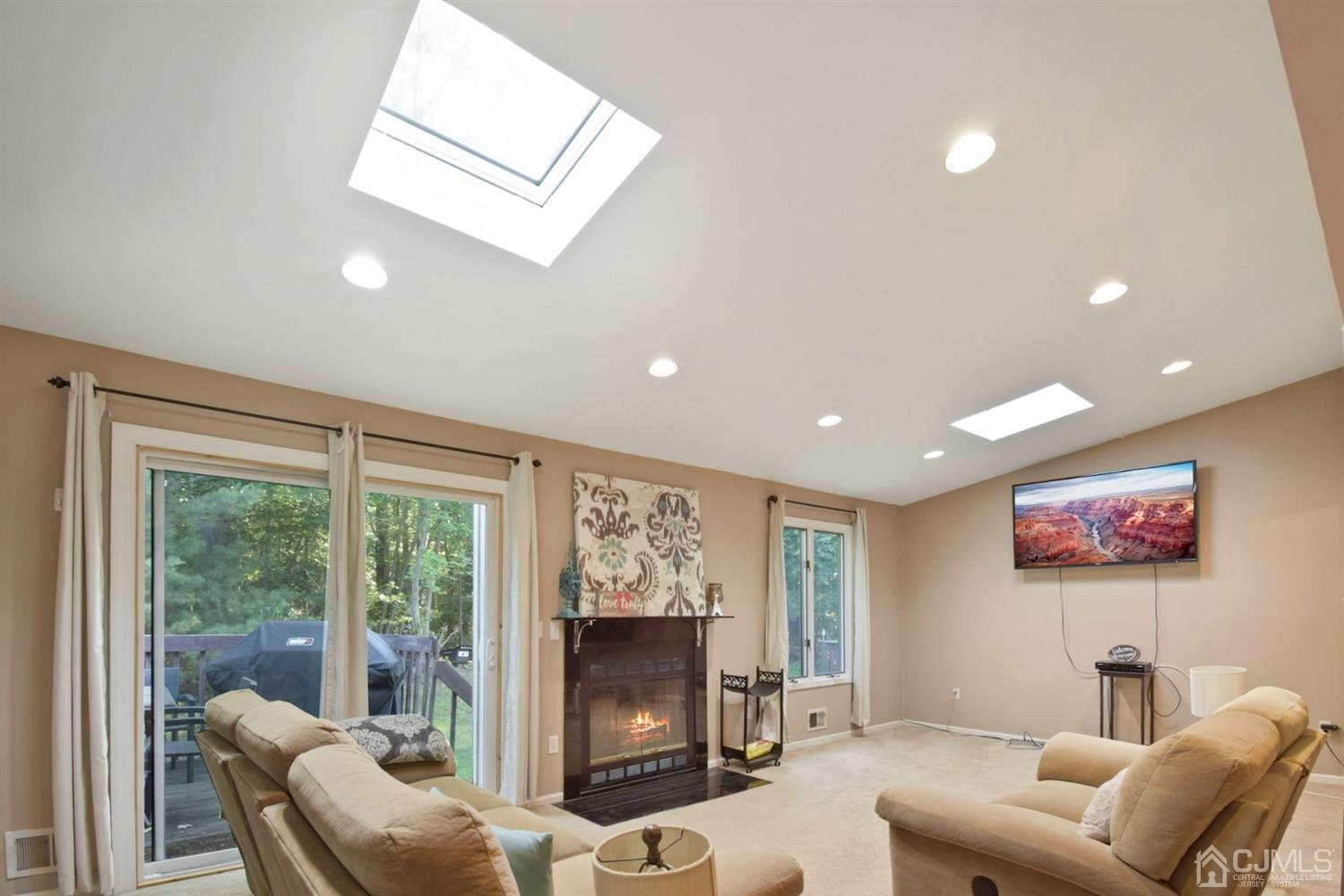 119 Redpine Loop Old Bridge, NJ 08857 - Photo 1 of 15 a living room with furniture a flat screen tv and a fireplace