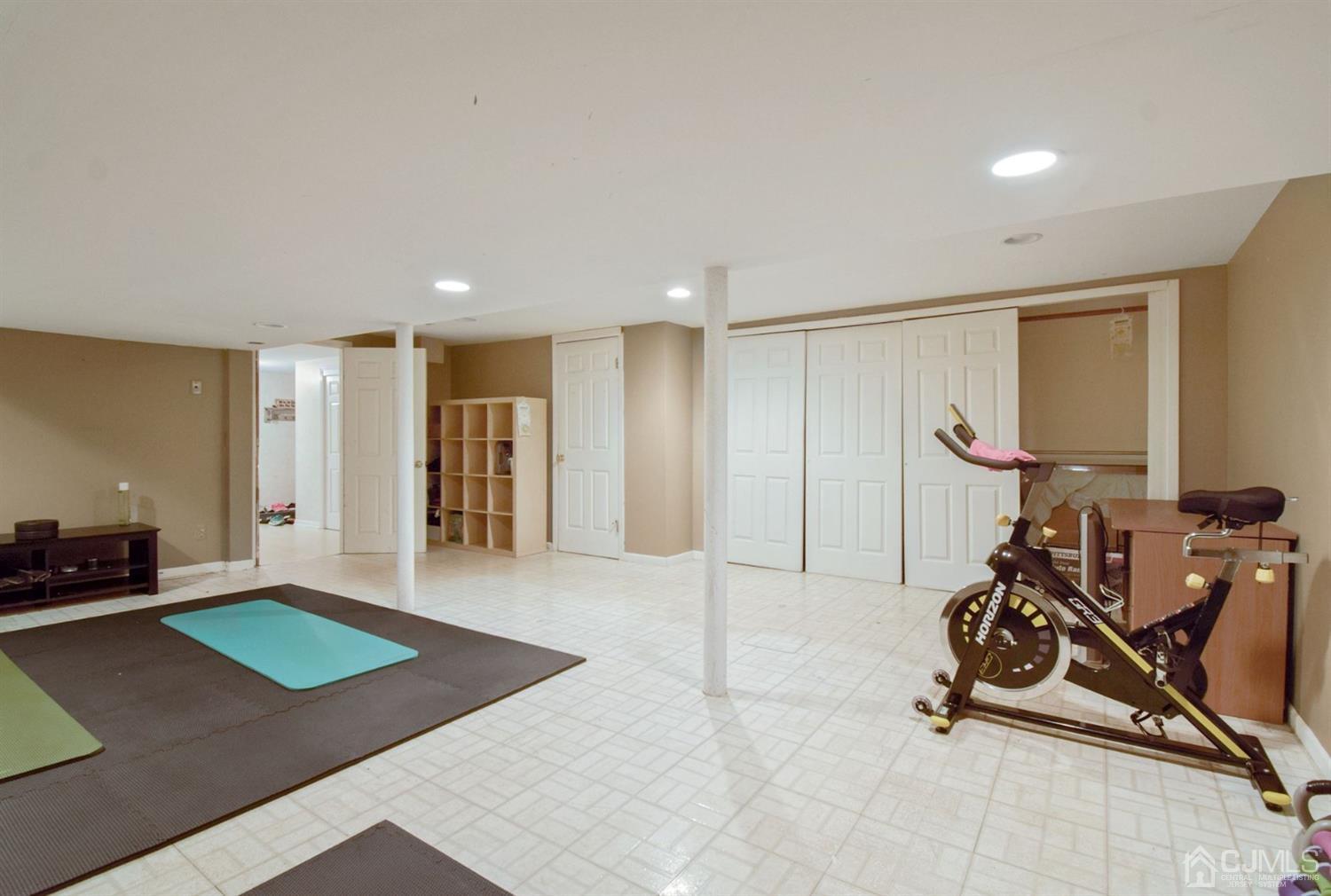 119 Redpine Loop Old Bridge, NJ 08857 - Photo 14 of 15 a room with gym equipment and a table