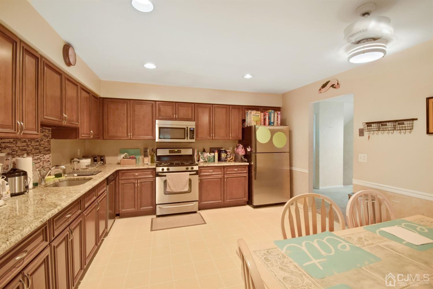 119 Redpine Loop Old Bridge, NJ 08857 - Photo 5 of 15 a kitchen with stainless steel appliances granite countertop a refrigerator stove microwave and sink